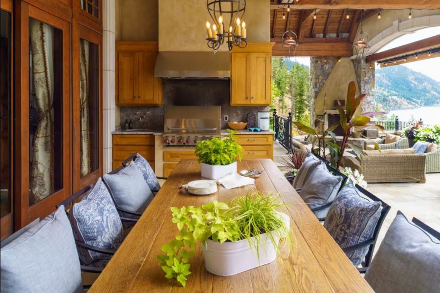 </who>The outdoor dining room and kitchen, above, the outdoor living room, below.