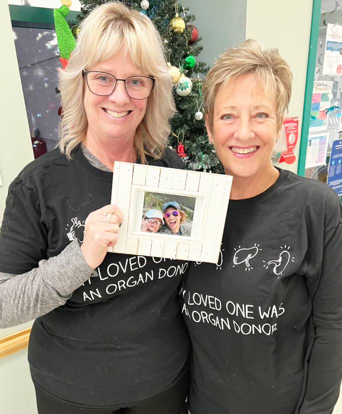 <who> Photo credit: LJI </who> Deanna Desjarlais and Debbie Lynn hold a picture of their son and nephew Cayden Desjarlais whose organ donation saved five lives.