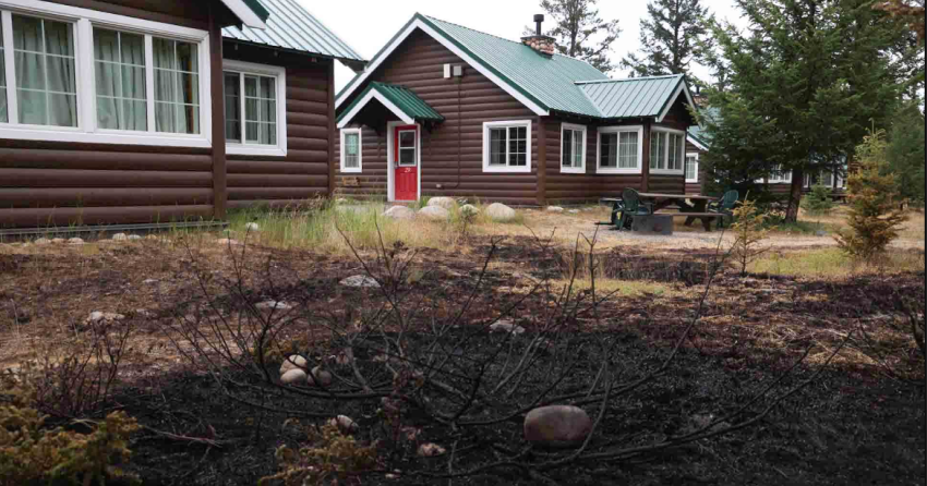 <who> Photo Credit: Parks Canada </who> A view of cabins at the Pine Bungalows Resort on the east side of Jasper.