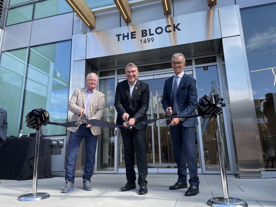 <who>Photo credit: Steve MacNaull/NowMedia Group</who>Cutting the ribbon to officially open The Block is Mark Hannah from Nicola Wealth Real Estate, left, Mayor Tom Dyas and Mission Group CEO Jonathan Friesen.