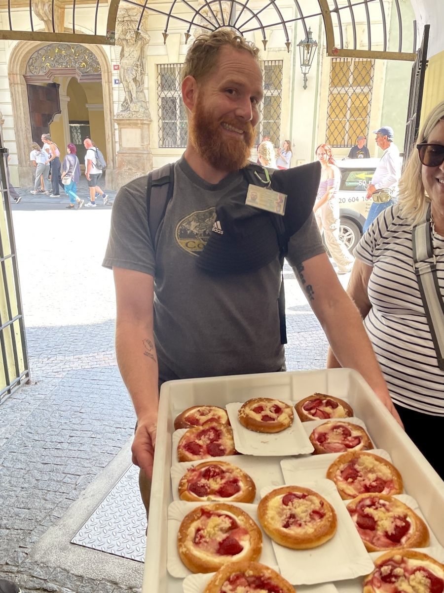 <who>Photo credits: Steve MacNaull/NowMedia Group</who>Our guide Zach McMahon brings out the ‘kolace’ pastries.