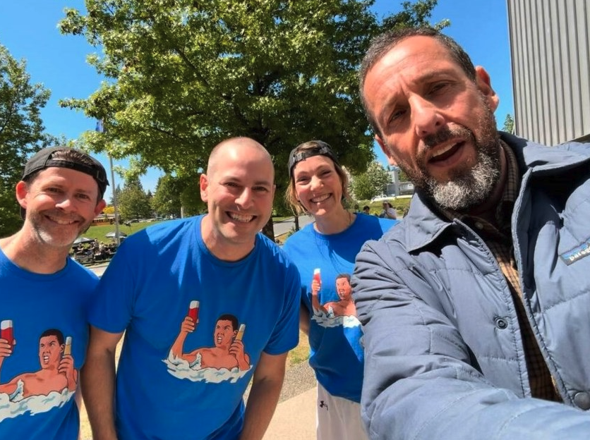 <who> Photo credit: LJI / Mark Barrett / LinkedIn </who> Adam Sandler takes a photo with Sutherland principal Mark Barrett and two vice-principals last week while on set.