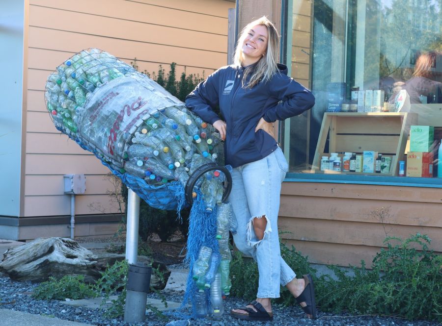 <who> Photo Credit: Nora O'Malley, Local Journalism Initiative Reporter</who> Lilly Woodbury, spokesperson for Surfrider Pacific Rim, leans on an art installation created by Tofino artist Pete Clarkson in collaboration with designer Kim Leckey.