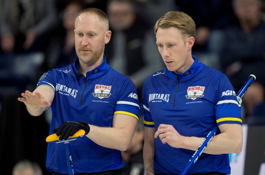 <who>Photo Credit: Curling Canada/Michael Burns</who>Brad Jacobs and Marc Kennedy talk things over during their playoff game against Team Canada on Friday afternoon.