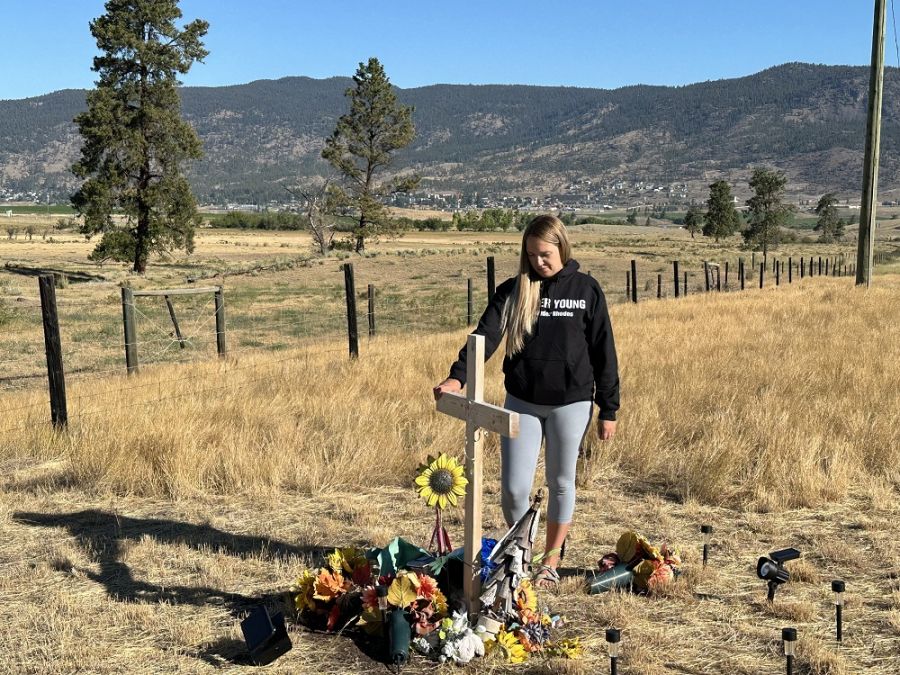 <who>Photo Credit: BC Highway Patrol</who>Alix Legouffe stands by a roadside memorial for her brother Buddy Rhodes.