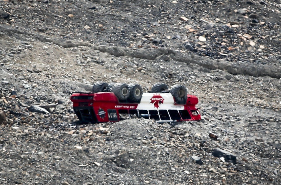 <who> Photo credit: Canadian Press </who> A rolled-over tour bus rests where it fell on the Columbia Icefield near Jasper, Alta., Sunday, July 19, 2020.