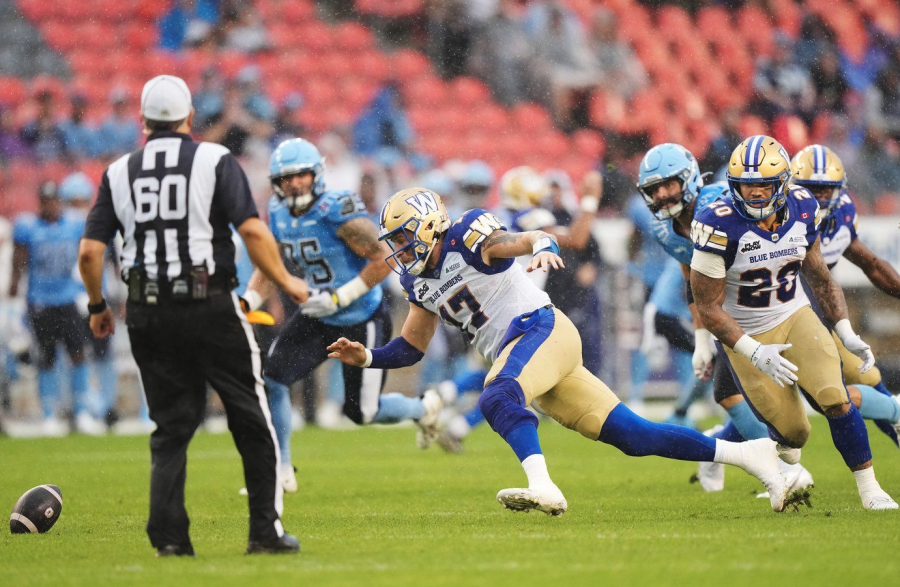 <who> Photo credit: Canadian Press </who> Winnipeg Blue Bombers quarterback Chris Streveler (17) scrambles to recover the football during first half CFL football action against the Toronto Argonauts in Toronto on Saturday, July 26, 2025.
