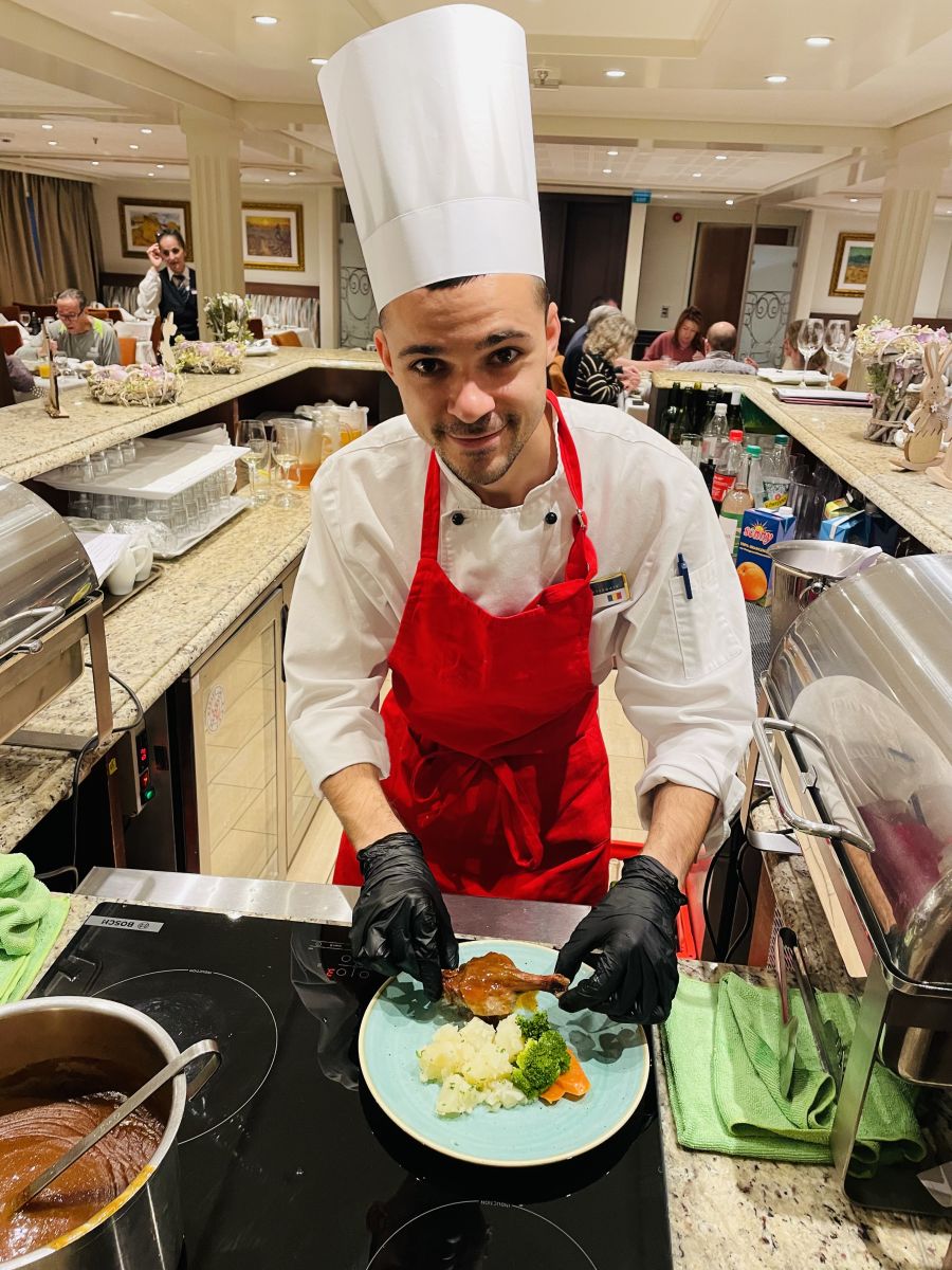 </who>Chef Florin plates duck confit aboard the AmaCello.