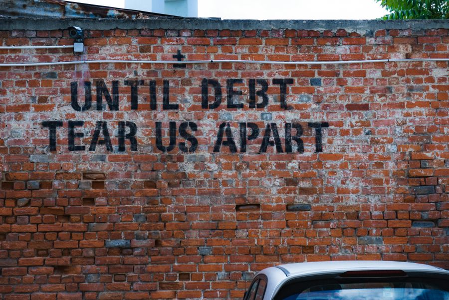 <who>Photo credit: Ehud Neuhaus on Unsplash</who>Sentiments about debt have even become graffiti and street art.