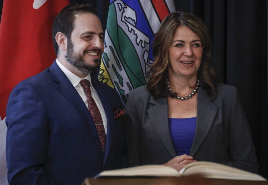 <who> Photo credit: Canadian Press </who> Alberta Premier Danielle Smith, right, stands with new Minister of Education and Childcare, Demetrios Nicolaides, following a swearing in ceremony in Calgary.