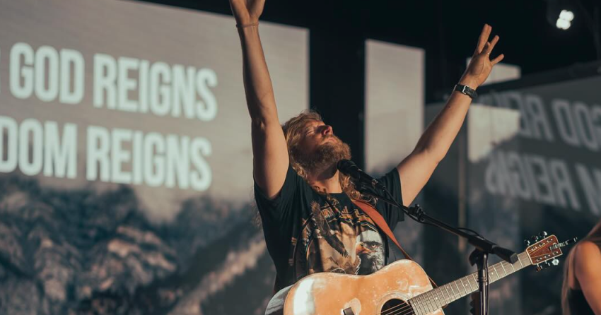 <who> Photo credit: Sean Feucht/Facebook </who> An image posted in July showing Feucht performing. 