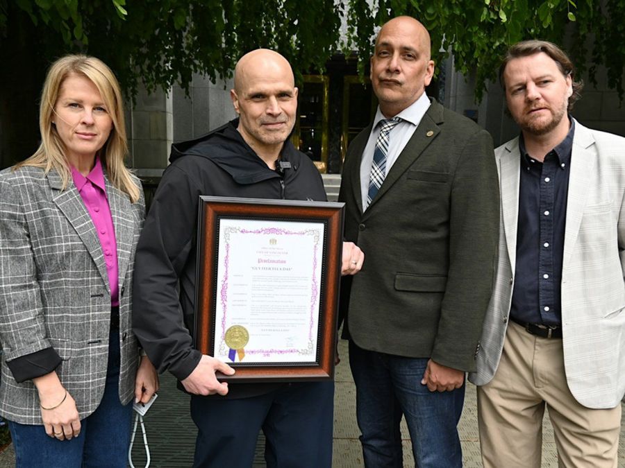 <who>Photo Credit: Local Journalism Initiative</who>Advocate Guy Felicella, flanked by supportive city councillors, returned a city honour in response to Mayor Ken Sim’s vow to block a downtown harm reduction site.