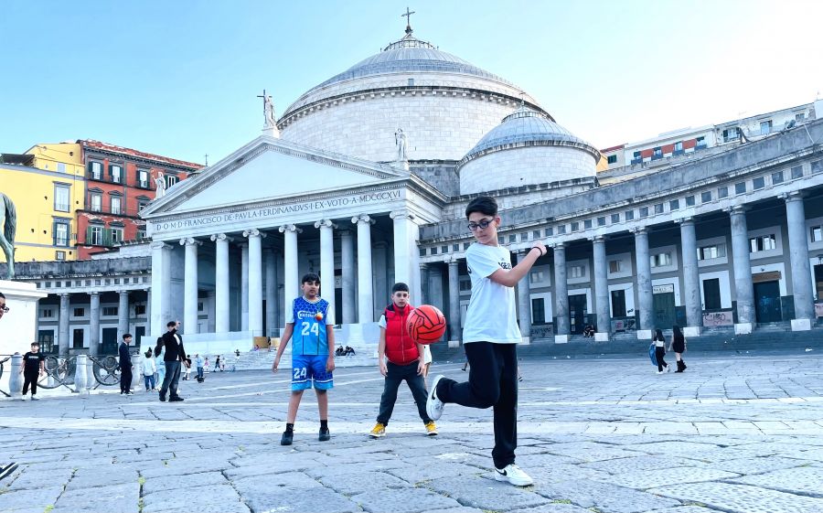 </who> Kids play soccer in Piazza del Plebiscito, Naples’ largest square.