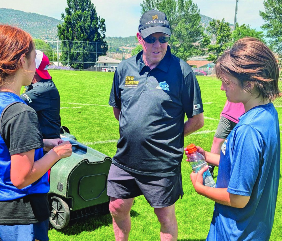 <who> Photo credit: LJI </who> Irish soccer legend Steve Staunton discusses the finer points of the game with a couple of local players during the inaugural Steve Staunton Summer Soccer Camp, which started Monday and wraps up Thursday at King's Park in Penticton.