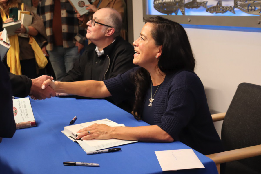 <who> Photo credit: Abby Luciano, Local Journalism Initiative </who> Jody Wilson-Raybould, one of the authors of Reconciling History: A Story of Canada, greets readers at a book launch at West Vancouver Memorial Library Sunday (Oct. 27).