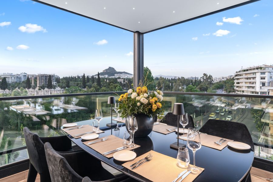 <who>Supplied by The Athenaeum</who>Pasithea rooftop bar and restaurant, above, has views of the Acropolis, the Temple of Zeus and Mount Lycabettus. Below, Pasithea restaurant features five neon-lit statues, including this one of Discobolus (the Greek discus thrower).