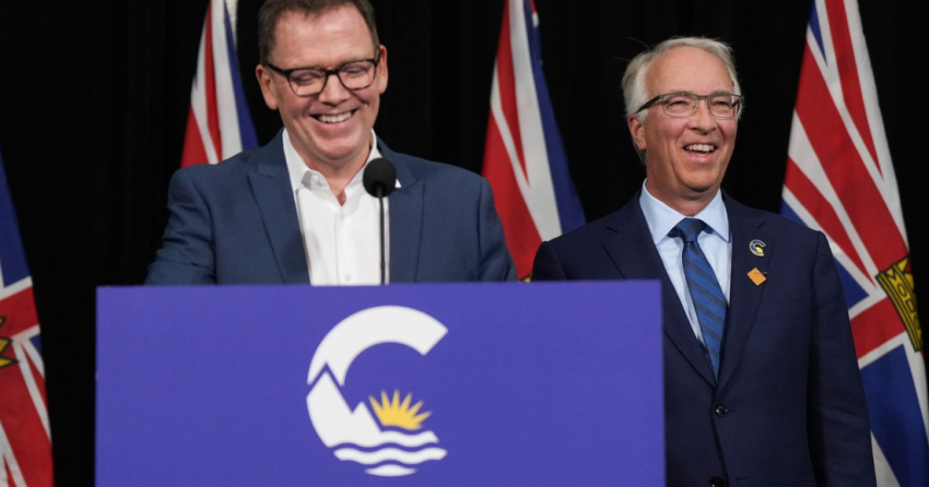 <who> Photo Credit: Canadian Press </who> Kevin Falcon (L) and John Rustad speak together at a press conference in Vancouver Wednesday afternoon.