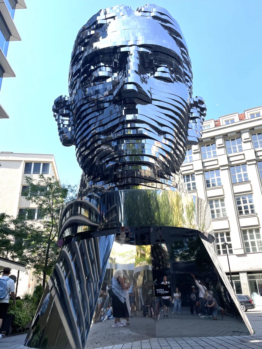 </who>The modernist sculpture of Czech writer Franz Kafka, who frequented Cafe Louvre in the early 1900s.