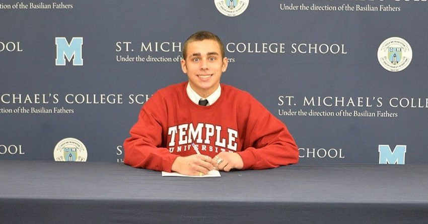 <who>Photo Credit: St. Michael's College/X</who>Tyler Sabapathy signs his commitment letter to Temple gymnastics in March 2024.