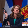 Alberta premier defends charging most Albertans for COVID-19 vaccines