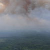Crews fight heavy winds as fire nears community in northeastern BC